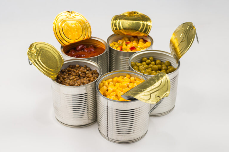 Canned food on white background. Green pea, beans, corn, lentils.